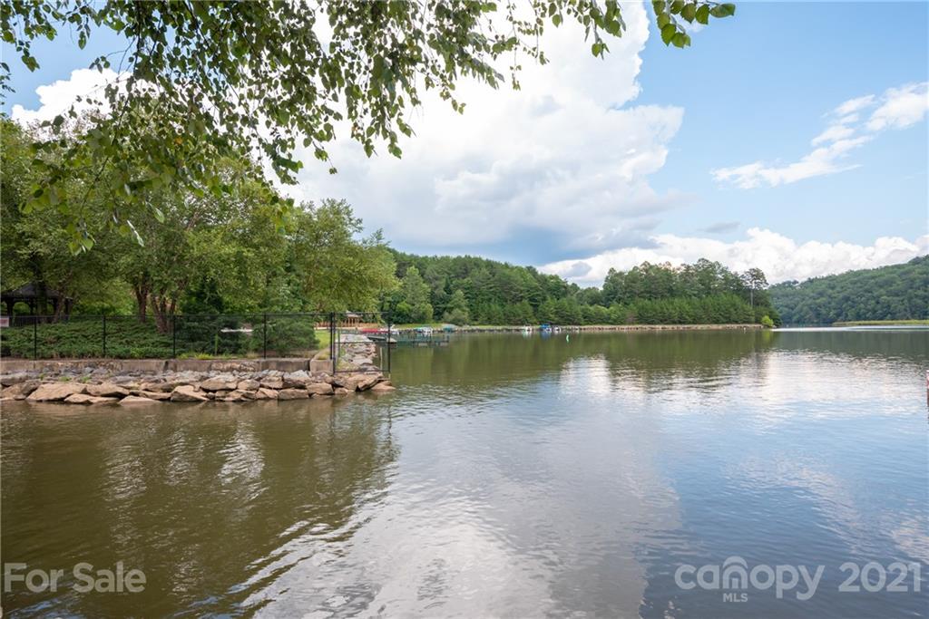 999 Parkway North Rd Mill Spring Mill Spring, NC 28756 - Photo 32 of 33 a view of a lake with houses in the background