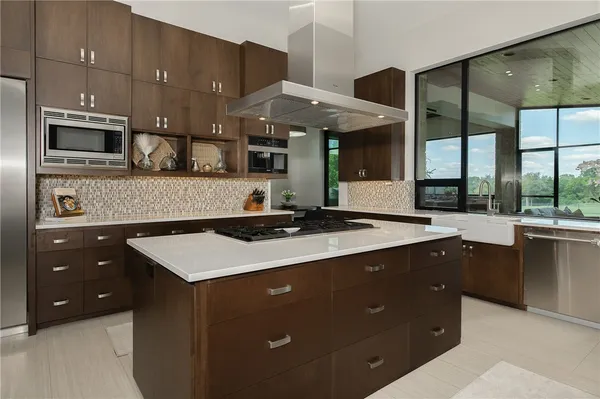 a kitchen with stainless steel appliances a sink stove and cabinets