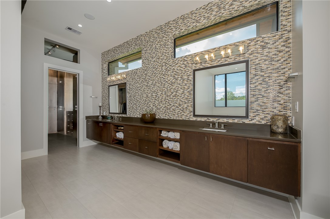 3320 Sycamore Trail Bryan, TX 77807 - Photo 23 of 49 Bathroom with backsplash, double vanity, a sink, and visible vents