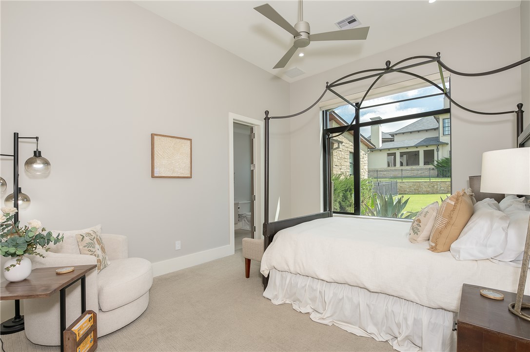 3320 Sycamore Trail Bryan, TX 77807 - Photo 27 of 48 a bedroom with a bed a chandelier and dresser