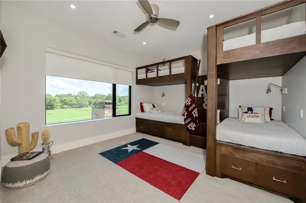 a bedroom with furniture and a large window