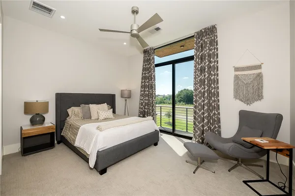 a spacious bedroom with a bed and a couch