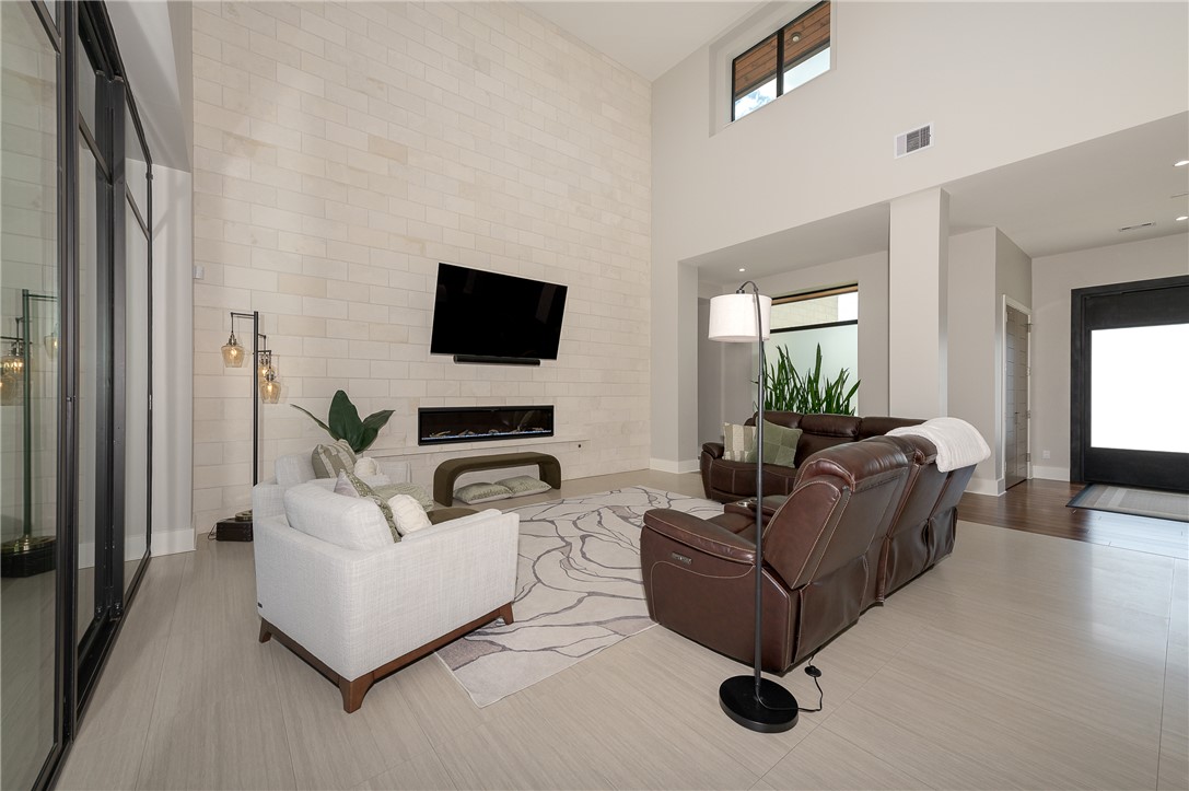 3320 Sycamore Trail Bryan, TX 77807 - Photo 44 of 49 Living area featuring plenty of natural light, baseboards, visible vents, and a towering ceiling