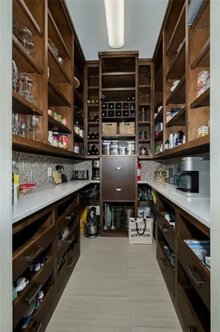 a kitchen with stainless steel appliances granite countertop a stove and a wooden cabinets