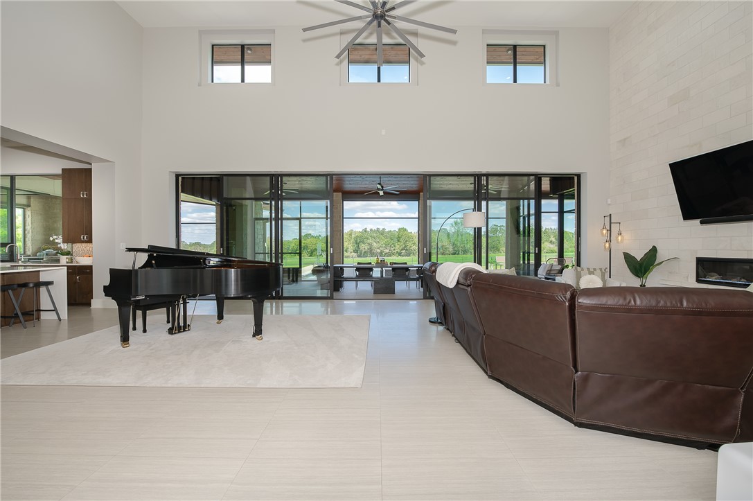 3320 Sycamore Trail Bryan, TX 77807 - Photo 7 of 49 Living room with a ceiling fan and a towering ceiling