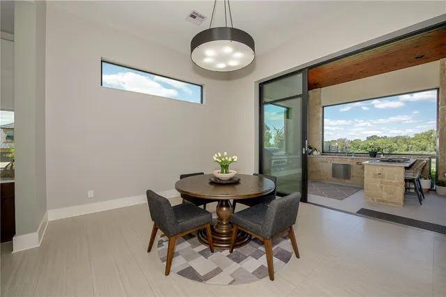 a view of a dining room with furniture wooden floor and a chandelier