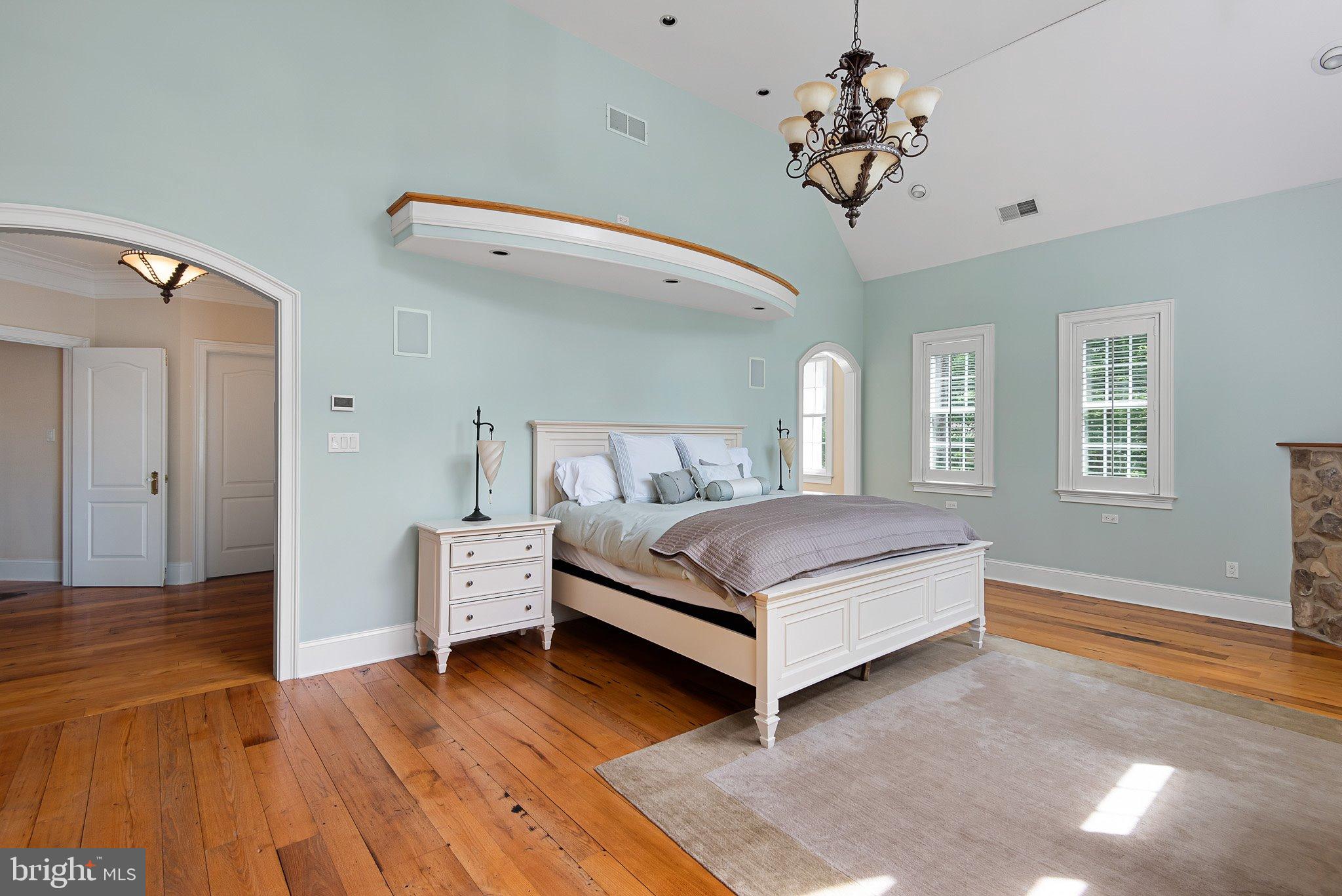 104 Timber Ridge Lane Chadds Ford, PA 19317 - Photo 28 of 65 a bedroom with a large bed and a chandelier