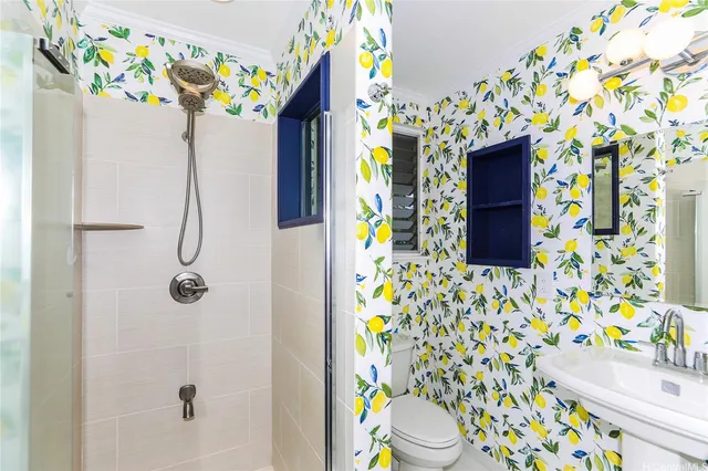 a bathroom with a sink a toilet and shower curtain