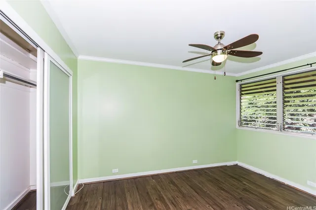 a view of an empty room with a window and a fan