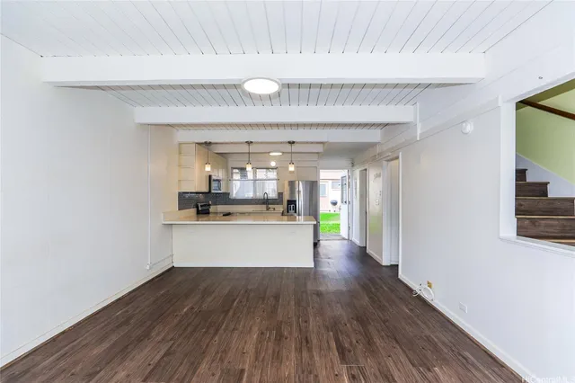 a room with wooden floor and windows