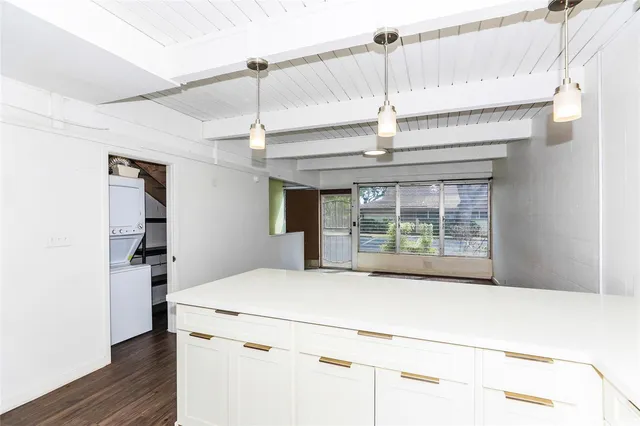 a kitchen with a stove and a chandelier