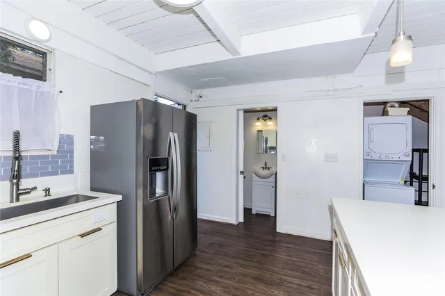 a kitchen with a refrigerator and a sink