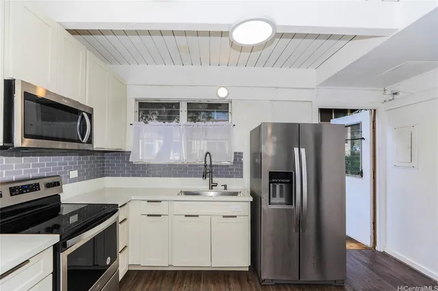 a kitchen with a sink stainless steel appliances and cabinets
