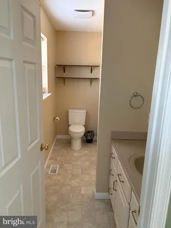 a bathroom with a sink a toilet and a shower