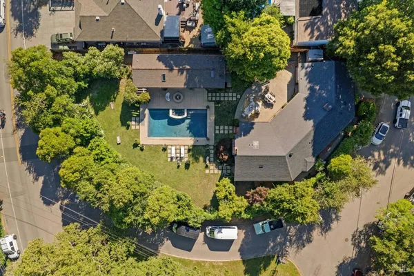 an aerial view of a house with a yard and garden in front of it