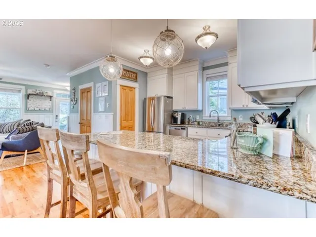 a kitchen with stainless steel appliances granite countertop a sink and cabinets