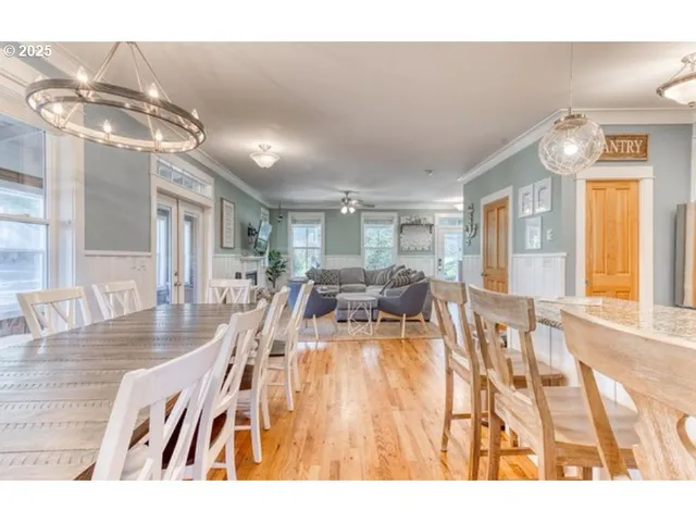 a living room with lots of furniture and chandelier