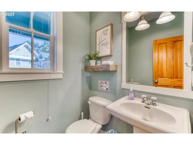 a bathroom with a sink mirror and toilet