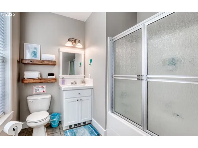 a bathroom with a toilet a sink and a mirror