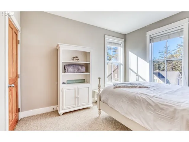 a spacious bedroom with a bed and a cabinets