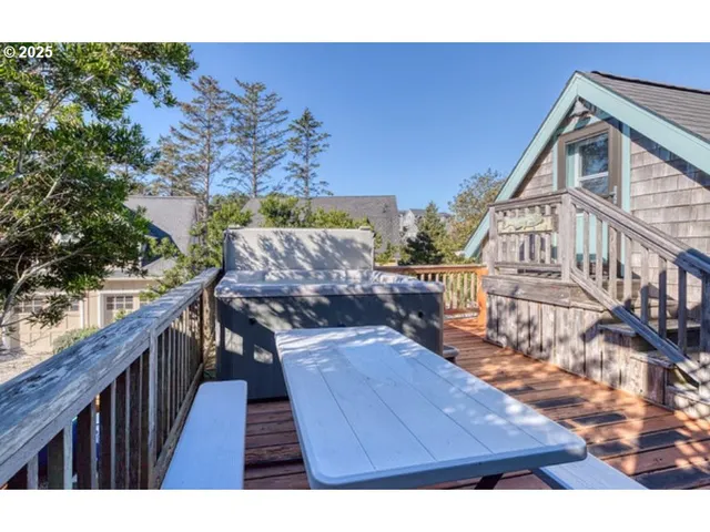 a view of a balcony with wooden floor and fence