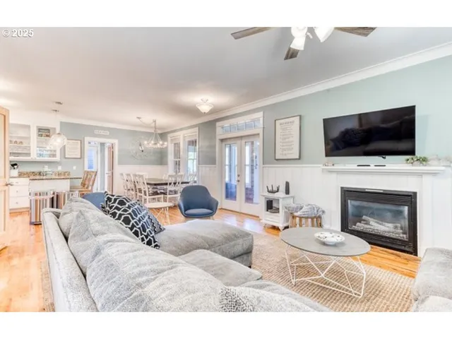 a living room with furniture a fireplace and a flat screen tv