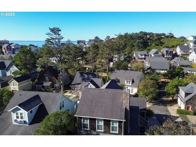 an aerial view of a house with a yard swimming pool and outdoor seating