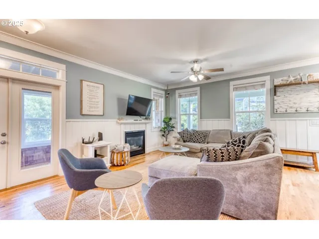 a living room with furniture a fireplace and a flat screen tv