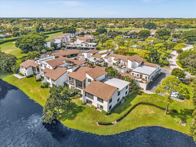 an aerial view of residential houses with outdoor space and swimming pool