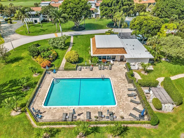 an aerial view of a house with yard swimming pool and outdoor seating