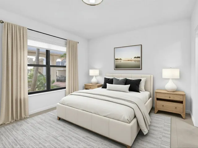 a bedroom with a large bed and a window