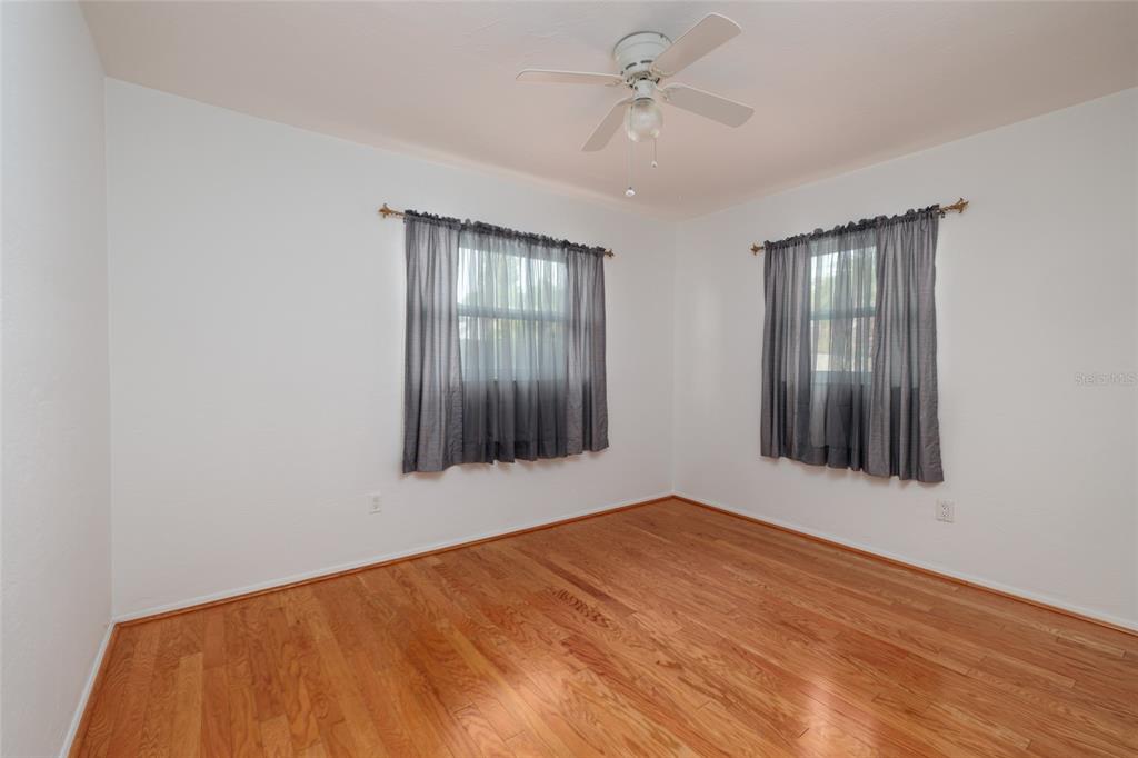 13877 94th Avenue North Seminole, FL 33776 - Photo 11 of 44 a view of an empty room with wooden floor and a window