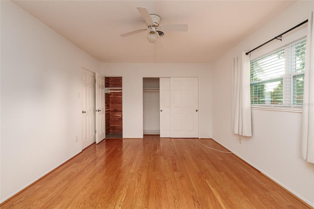 13877 94th Avenue North Seminole, FL 33776 - Photo 16 of 44 a view of an empty room with wooden floor and a window
