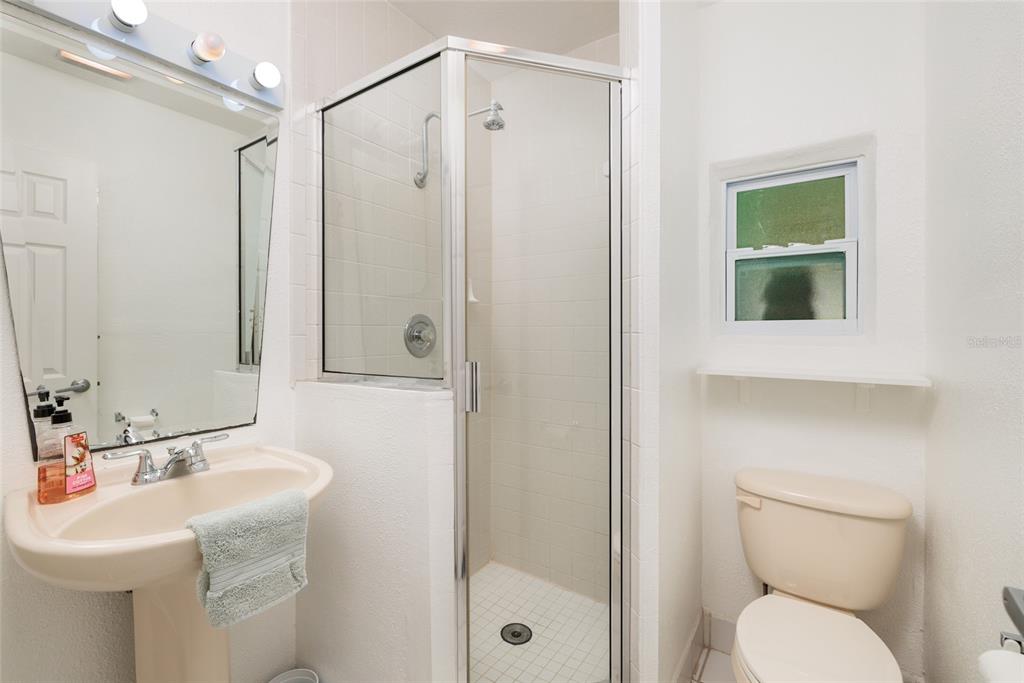 13877 94th Avenue North Seminole, FL 33776 - Photo 19 of 44 a bathroom with a toilet a sink and a mirror