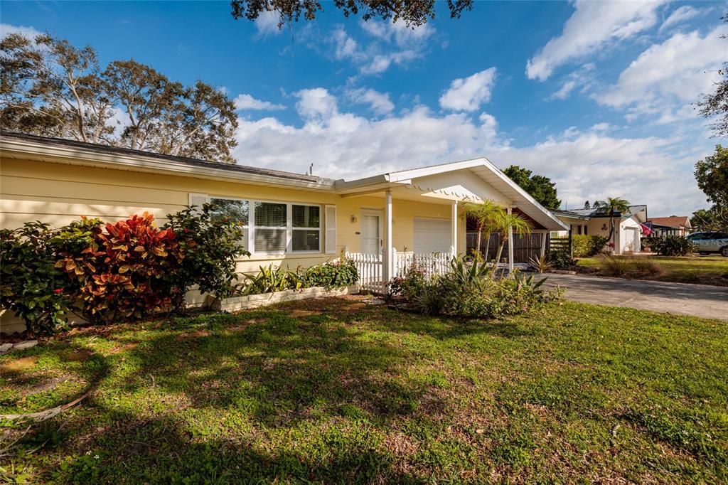 13877 94th Avenue North Seminole, FL 33776 - Photo 2 of 44 a view of a house with a big yard and potted plants
