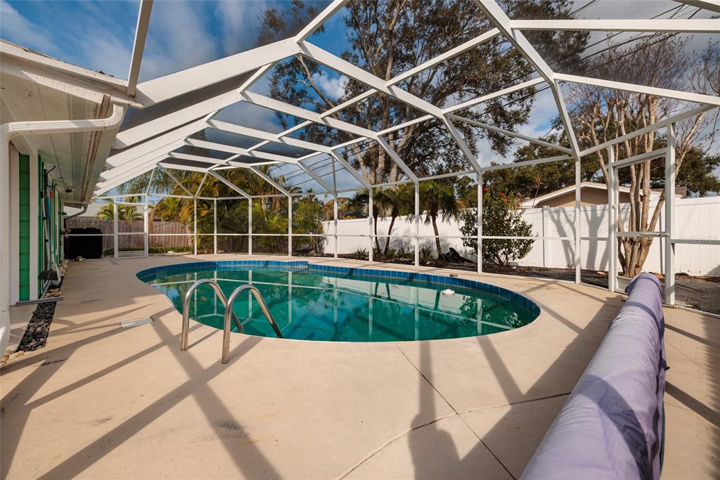 13877 94th Avenue North Seminole, FL 33776 - Photo 26 of 44 a view of a swimming pool with a patio