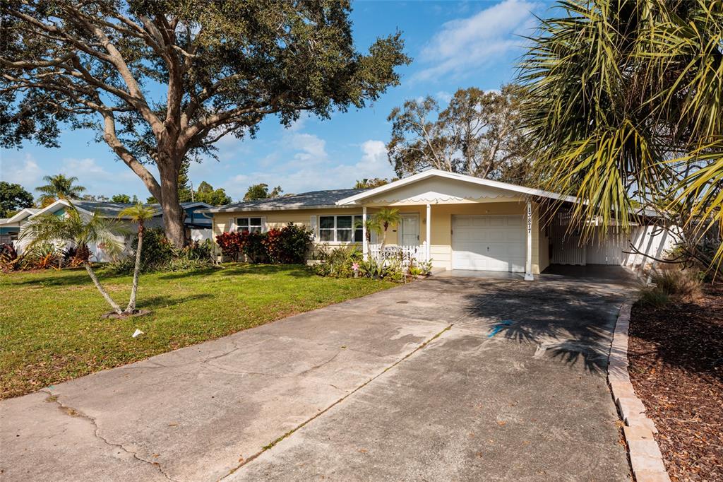 13877 94th Avenue North Seminole, FL 33776 - Photo 34 of 44 a view of a house with a yard