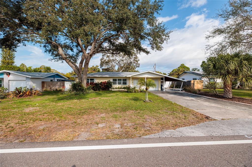 13877 94th Avenue North Seminole, FL 33776 - Photo 36 of 44 a front view of a house with a yard