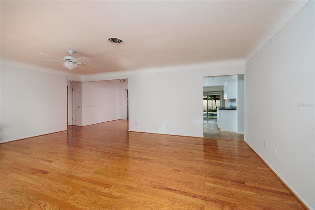13877 94th Avenue North Seminole, FL 33776 - Photo 7 of 44 a view of an empty room with wooden floor and cabinet