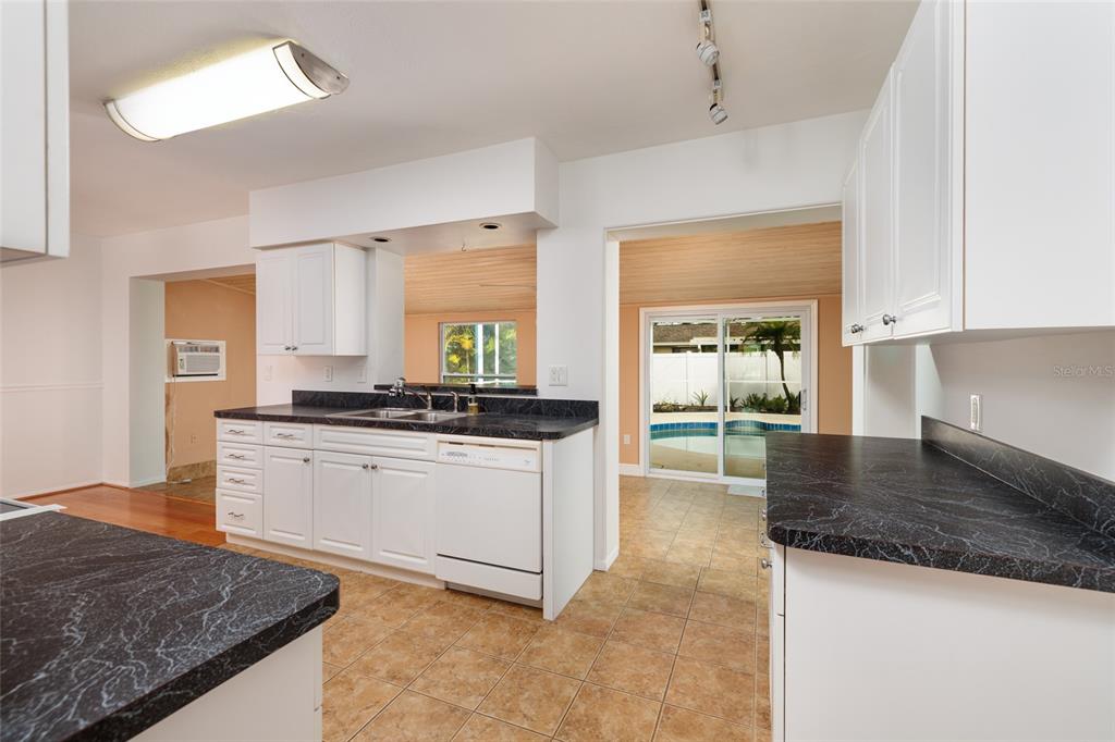 13877 94th Avenue North Seminole, FL 33776 - Photo 10 of 44 a kitchen with granite countertop white cabinets and a granite counter tops