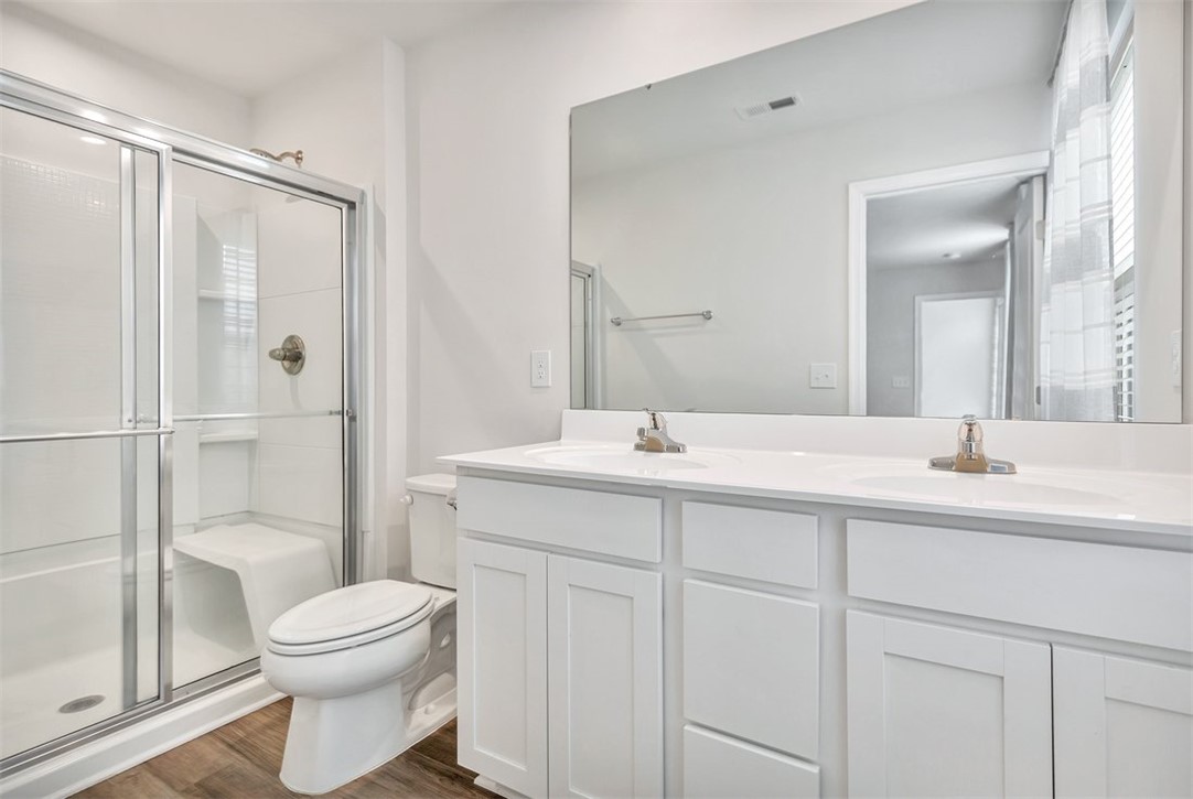 150 Queens Mill Court Pendleton, SC 29670 - Photo 25 of 37 This bright bathroom features a spacious shower and a vanity with dual sinks.