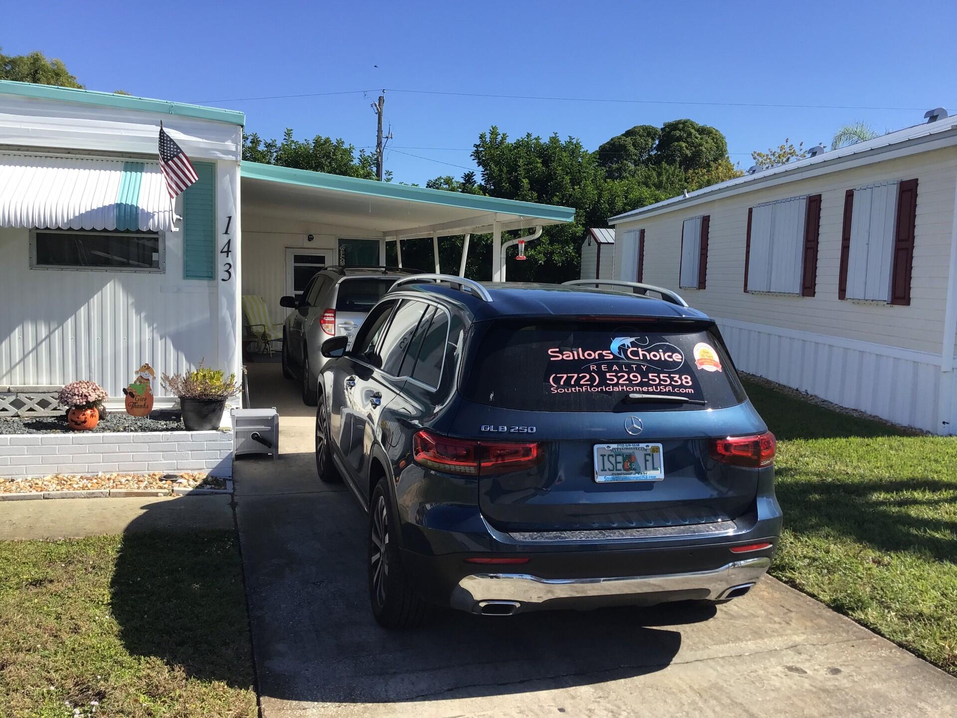 143 Southeast Easy Street Stuart, FL 34994 - Photo 1 of 12 a front view of a house with garden