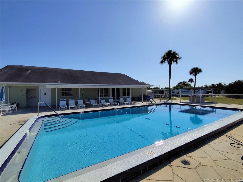 143 Southeast Easy Street Stuart, FL 34994 - Photo 9 of 12 a view of a swimming pool with chairs