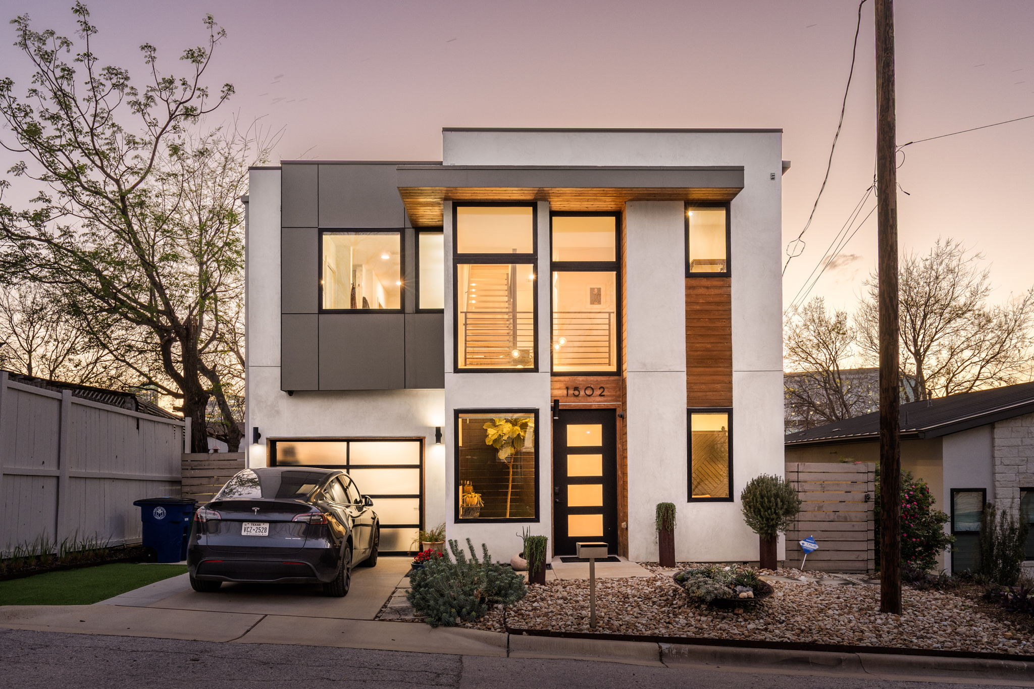 Contemporary house featuring stucco siding, driveway, and an attached garage