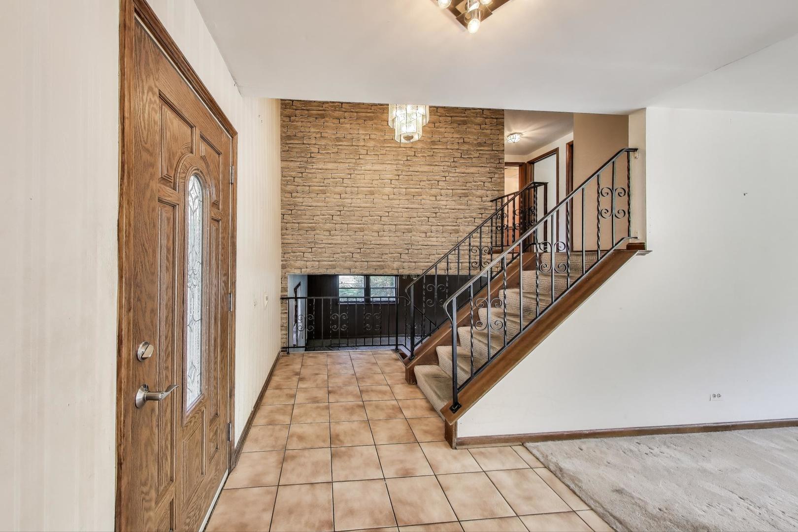 3509 Lawson Road Glenview, IL 60026 - Photo 3 of 54 a view of staircase with white walls and railing