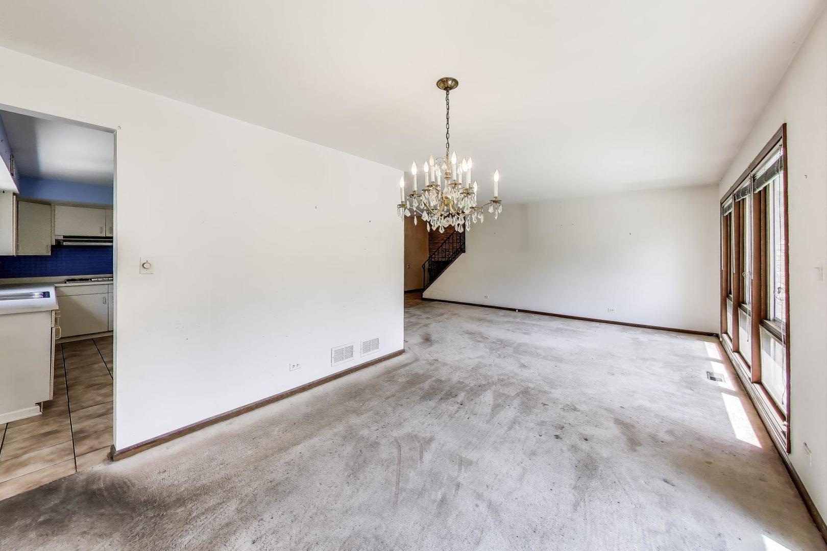 3509 Lawson Road Glenview, IL 60026 - Photo 7 of 54 a view of a hallway with a chandelier