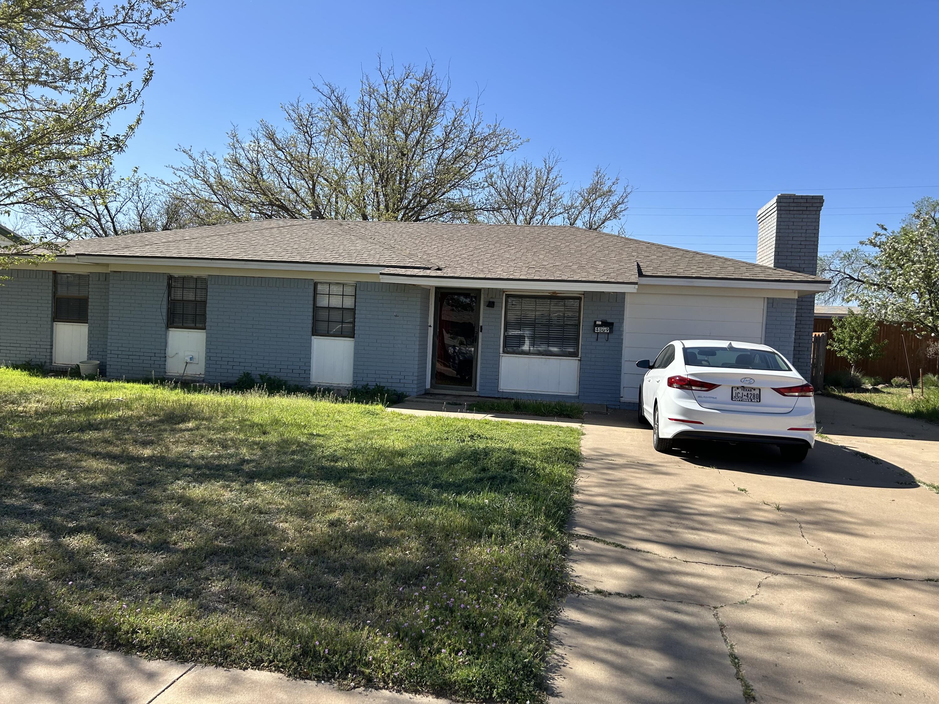 4809 8th Street Lubbock, TX 79416 - Photo 1 of 14 a front view of a house with a garden