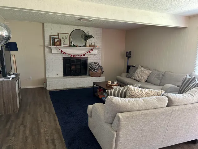 a living room with furniture and a fireplace