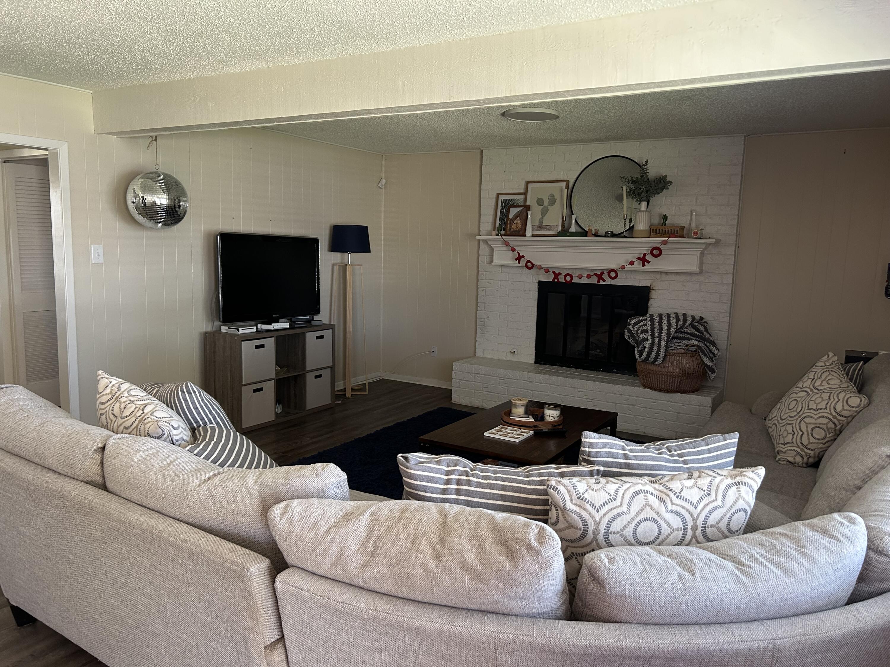 4809 8th Street Lubbock, TX 79416 - Photo 3 of 14 a living room with furniture and a flat screen tv