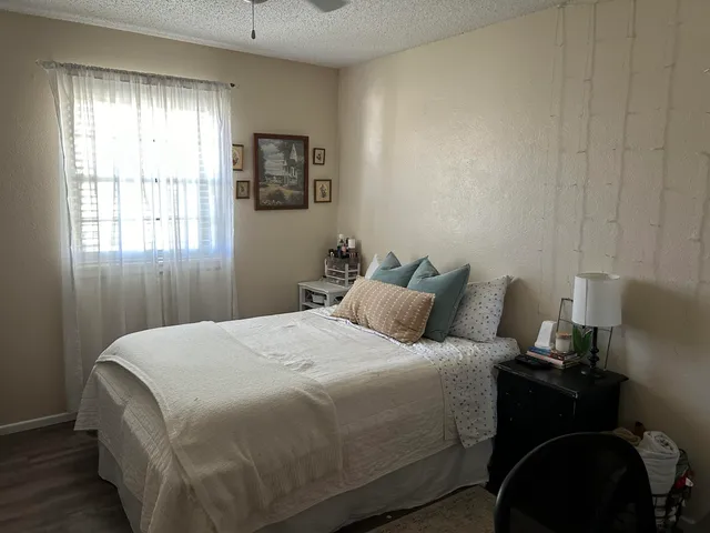 a bedroom with a bed and window